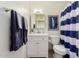 Charming bathroom features white vanity, stylish blue striped shower curtain at 316 N Ironwood --, Mesa, AZ 85201