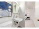 Bright bathroom featuring a white sink, vanity, and artistic blue wall decor at 316 N Ironwood --, Mesa, AZ 85201