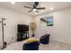 Spacious bedroom featuring a ceiling fan, TV, and cozy beanbag chairs at 316 N Ironwood --, Mesa, AZ 85201