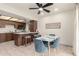 Eat-in kitchen featuring tile flooring, a ceiling fan, and an adjacent breakfast bar at 316 N Ironwood --, Mesa, AZ 85201