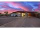 Charming single-story home with a spacious driveway and covered parking under a colorful sunset sky at 316 N Ironwood --, Mesa, AZ 85201