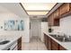 Galley kitchen featuring white appliances, wooden cabinets, and bright overhead lighting at 316 N Ironwood --, Mesa, AZ 85201