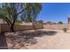 Large backyard offers shade from a mature tree and a stone patio perfect for outdoor living at 33512 N 24Th Ln, Phoenix, AZ 85085