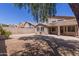 Large backyard with rock landscaping, privacy wall, and covered patio at 33512 N 24Th Ln, Phoenix, AZ 85085