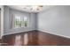 Spacious bedroom with hardwood floors, large window, and ceiling fan at 33512 N 24Th Ln, Phoenix, AZ 85085