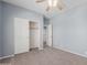 Bedroom featuring neutral carpet, fan, and walk-in closet at 33512 N 24Th Ln, Phoenix, AZ 85085