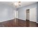 Spacious bedroom with hardwood floors, fan, and walk-in closet at 33512 N 24Th Ln, Phoenix, AZ 85085
