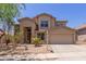 Two-story home with desert landscaping and a two car garage at 33512 N 24Th Ln, Phoenix, AZ 85085