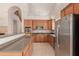 Kitchen with stainless steel refrigerator, wooden cabinets, and breakfast bar at 33512 N 24Th Ln, Phoenix, AZ 85085