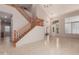 Spacious living room featuring a grand staircase and tiled floors at 33512 N 24Th Ln, Phoenix, AZ 85085
