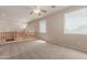 Spacious loft area with a ceiling fan and a view of the lower level at 33512 N 24Th Ln, Phoenix, AZ 85085