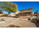 This backyard features gravel landscaping, a covered patio, and room for outdoor activities at 33602 N Cobble Stone Dr, San Tan Valley, AZ 85143