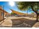 Extensive backyard featuring gravel, concrete pad, landscaping, sunshade and mature trees at 33602 N Cobble Stone Dr, San Tan Valley, AZ 85143