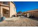 Backyard features a concrete pad next to a two-story home with a gravel side yard at 33602 N Cobble Stone Dr, San Tan Valley, AZ 85143