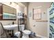 Bathroom with commode, vanity, mirror, shelving and patterned shower curtain at 33602 N Cobble Stone Dr, San Tan Valley, AZ 85143