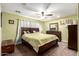 Comfortable bedroom with a queen-sized bed, dresser, carpet floors, and a ceiling fan at 33602 N Cobble Stone Dr, San Tan Valley, AZ 85143