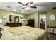 Spacious bedroom featuring a bed, dresser, carpet floors, and an ensuite bathroom at 33602 N Cobble Stone Dr, San Tan Valley, AZ 85143