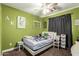 This bright bedroom is accented with black-out curtains and a ceiling fan at 33602 N Cobble Stone Dr, San Tan Valley, AZ 85143