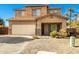 Charming two-story home boasts a two-car garage and a cozy covered porch at 33602 N Cobble Stone Dr, San Tan Valley, AZ 85143