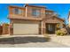 Charming two-story home boasts a two-car garage and a cozy covered porch at 33602 N Cobble Stone Dr, San Tan Valley, AZ 85143