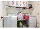 Bright laundry room featuring a washer, dryer, shelving, and storage at 33602 N Cobble Stone Dr, San Tan Valley, AZ 85143
