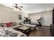 Comfortable living room with stylish sectional sofa and ceiling fan at 33602 N Cobble Stone Dr, San Tan Valley, AZ 85143