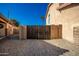 Side yard access gate with privacy fence and desert landscaping at 33602 N Cobble Stone Dr, San Tan Valley, AZ 85143