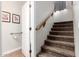 A carpeted staircase leading upstairs with a wooden handrail, next to a bathroom at 33602 N Cobble Stone Dr, San Tan Valley, AZ 85143