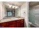Bathroom with a single sink vanity, large mirror, and a glass-enclosed shower at 3500 N Hayden Rd # 710, Scottsdale, AZ 85251