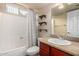 Bathroom featuring a tub, toilet, shelves, vanity and mirror with good lighting at 3500 N Hayden Rd # 710, Scottsdale, AZ 85251