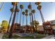 Low angle view of modern condo units surrounding a fountain, palm trees and green lawn at 3500 N Hayden Rd # 710, Scottsdale, AZ 85251