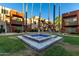 Charming condo community featuring a central water fountain, palm trees and landscaped yard at 3500 N Hayden Rd # 710, Scottsdale, AZ 85251