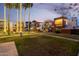 Exterior of a modern apartment complex featuring a fountain, trees, and well-manicured lawn at 3500 N Hayden Rd # 710, Scottsdale, AZ 85251