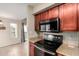 Well-equipped kitchen featuring a black range, microwave, granite counters, and natural light at 3500 N Hayden Rd # 710, Scottsdale, AZ 85251
