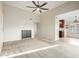 Open-concept living room view into adjacent dining and kitchen area, featuring neutral carpet and a contemporary ceiling fan at 3500 N Hayden Rd # 710, Scottsdale, AZ 85251
