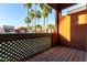 Patio with wood decking and latticework overlooking palm trees in natural daylight at 3500 N Hayden Rd # 710, Scottsdale, AZ 85251