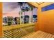 Patio with wood decking and latticework overlooking well-lit palm trees at 3500 N Hayden Rd # 710, Scottsdale, AZ 85251