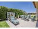 Beautiful backyard with a water feature, lounge chair, and comfortable patio seating, ideal for relaxing at 35486 N Morello Dr, Queen Creek, AZ 85140