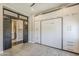 Stylish bedroom featuring a murphy bed, built-in storage cabinets, and decorative sliding wood door at 35486 N Morello Dr, Queen Creek, AZ 85140