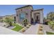 Charming home featuring a stone facade, desert landscaping, and a welcoming brick walkway at 35486 N Morello Dr, Queen Creek, AZ 85140