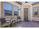 Relaxing front porch with table and chairs, perfect for enjoying the outdoors at 35486 N Morello Dr, Queen Creek, AZ 85140
