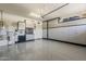Well-organized garage featuring epoxy flooring, ample storage cabinets, and overhead lighting at 35486 N Morello Dr, Queen Creek, AZ 85140