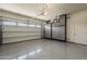Clean and organized garage with epoxy floors, storage cabinets and an automatic door at 35486 N Morello Dr, Queen Creek, AZ 85140