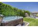 Relaxing hot tub surrounded by lush greenery, creating a private and serene backyard oasis at 35486 N Morello Dr, Queen Creek, AZ 85140