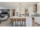 Open concept kitchen with a large island, pendant lighting, and stainless steel appliances at 35486 N Morello Dr, Queen Creek, AZ 85140
