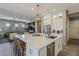 Beautiful kitchen with island, stainless appliances, and views of the living area at 35486 N Morello Dr, Queen Creek, AZ 85140