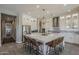Spacious kitchen featuring a large center island with seating and stainless steel appliances at 35486 N Morello Dr, Queen Creek, AZ 85140