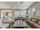 Comfortable living room with a ceiling fan, neutral decor, and open layout at 35486 N Morello Dr, Queen Creek, AZ 85140