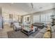 Open-concept living room with a large kitchen and dining area visible from the seating area at 35486 N Morello Dr, Queen Creek, AZ 85140
