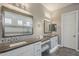 This main bathroom features double sinks, a make up station, decorative tile backsplash, and modern lighting at 35486 N Morello Dr, Queen Creek, AZ 85140